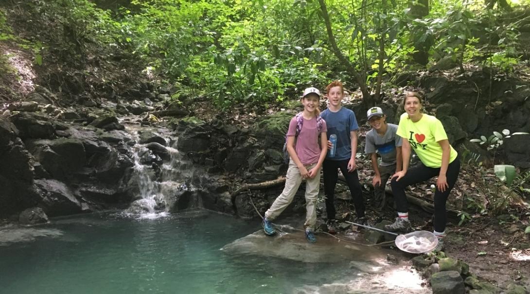 Middle school students stop by the waters edge while completing a wildlife survey in Costa Rica Projects Abroad volunteers take a break in the forest during their Conservation Project